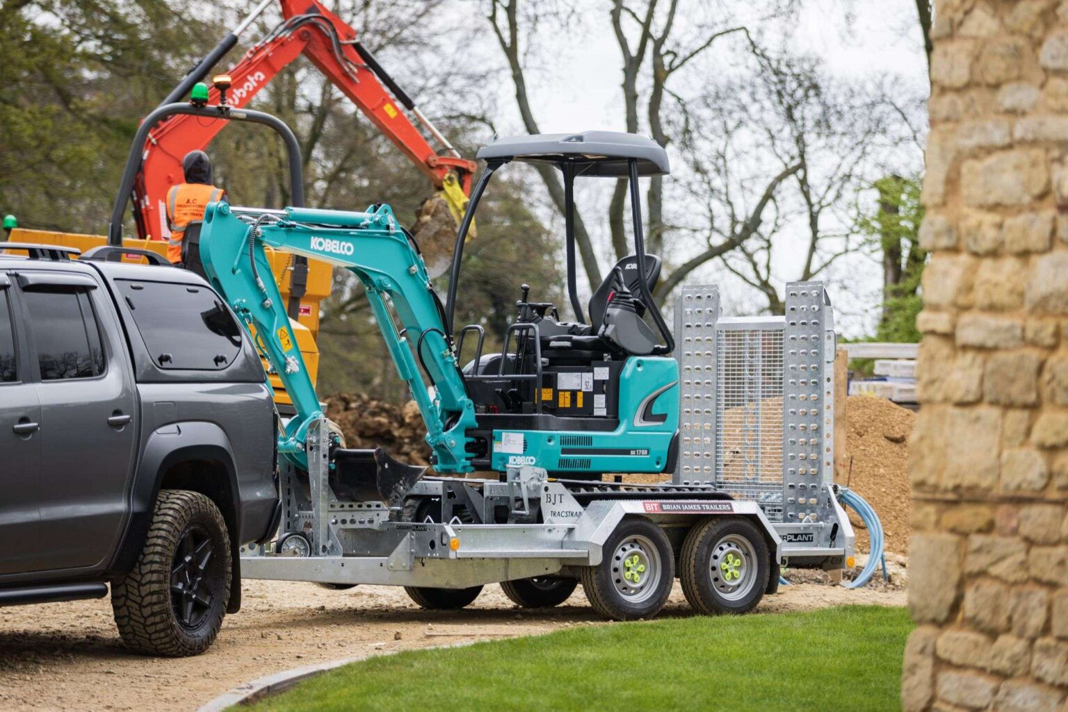 Brian James plant trailer transporting mini excavator attached to pickup truck on construction site