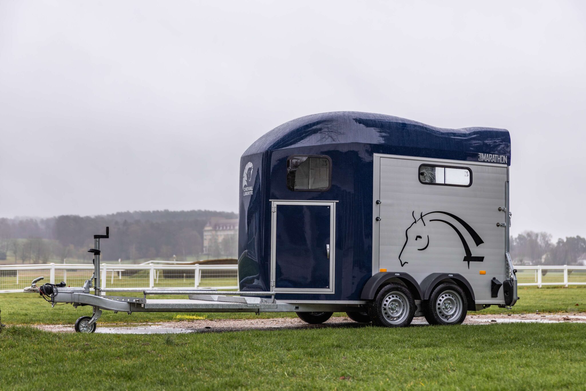 Cheval Liberté Marathon horse trailer with front access door and rear ramp parked in countryside setting
