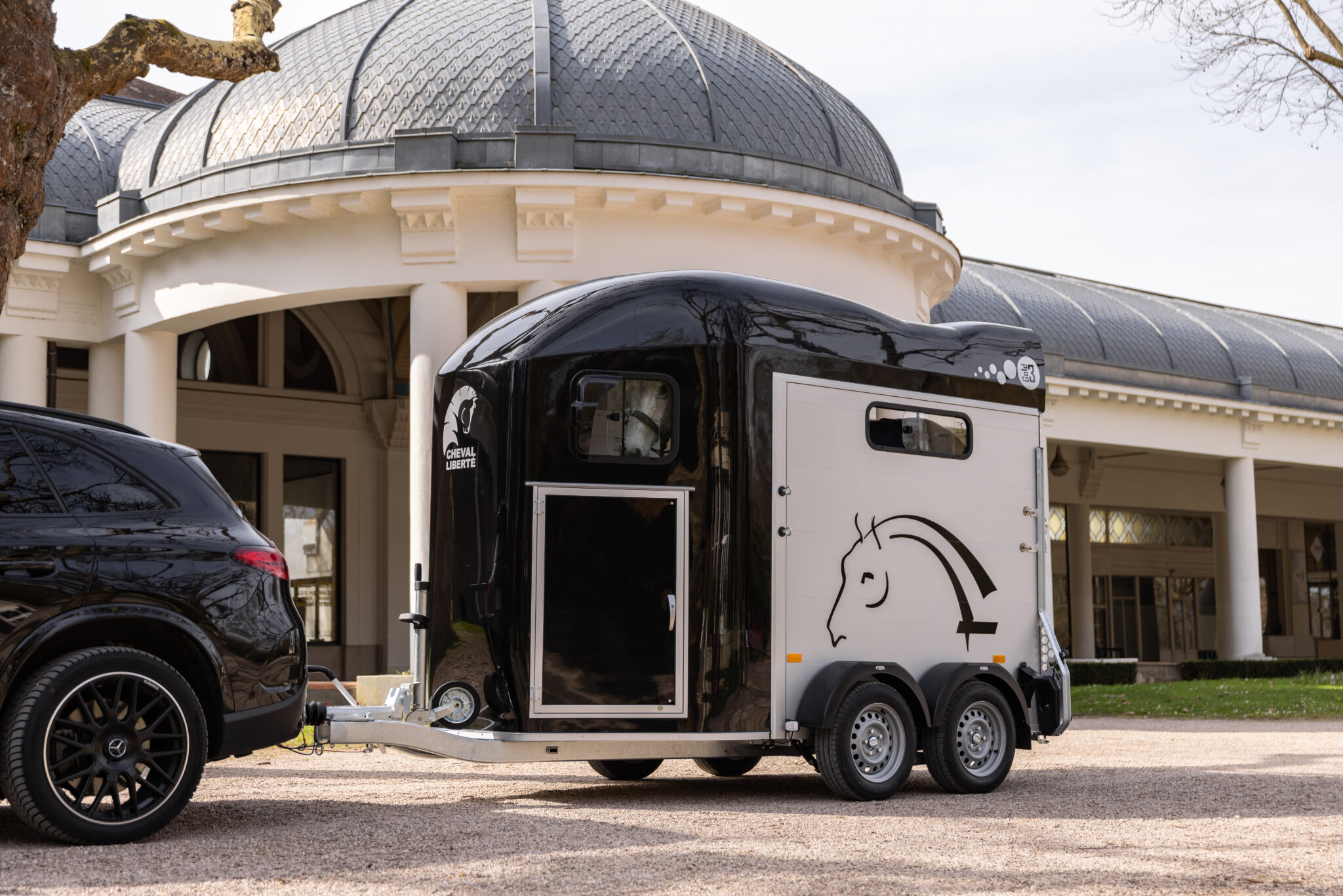 Cheval Liberte Horse Box Equestrian Transporter being towed by SUV outdoors