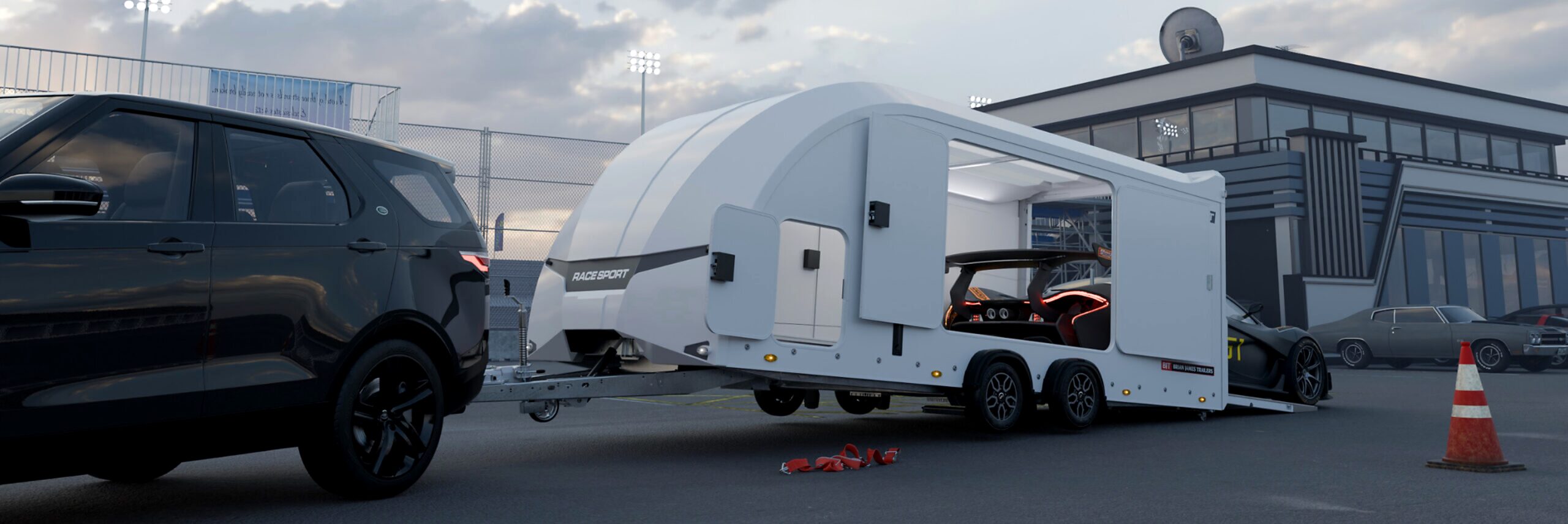 Brian James Enclosed vehicle transporter trailer with loading ramp and sports car