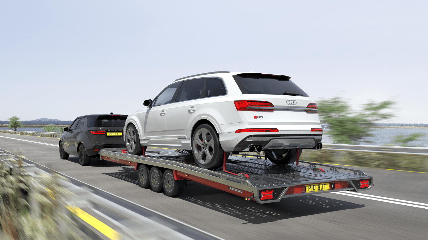 Brian James open car transporter trailer towing Audi SUV on motorway