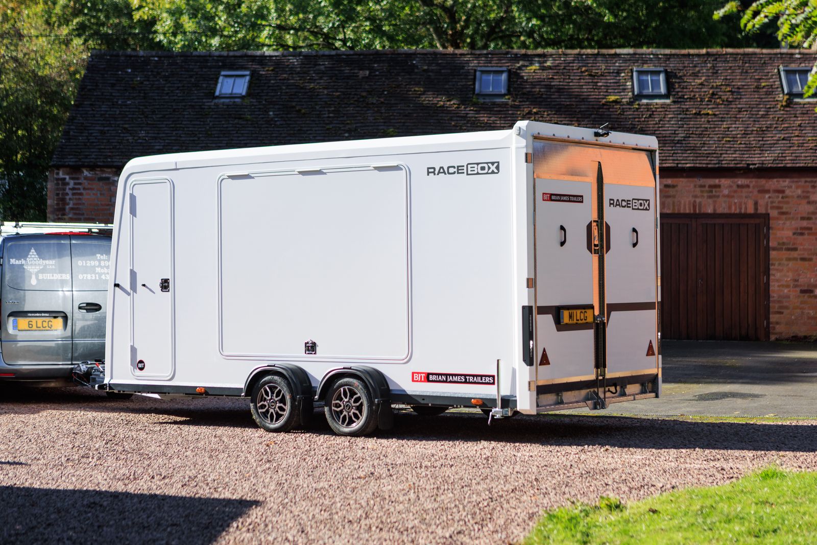 Brian James enclosed car transporter trailer parked with rear loading ramp open