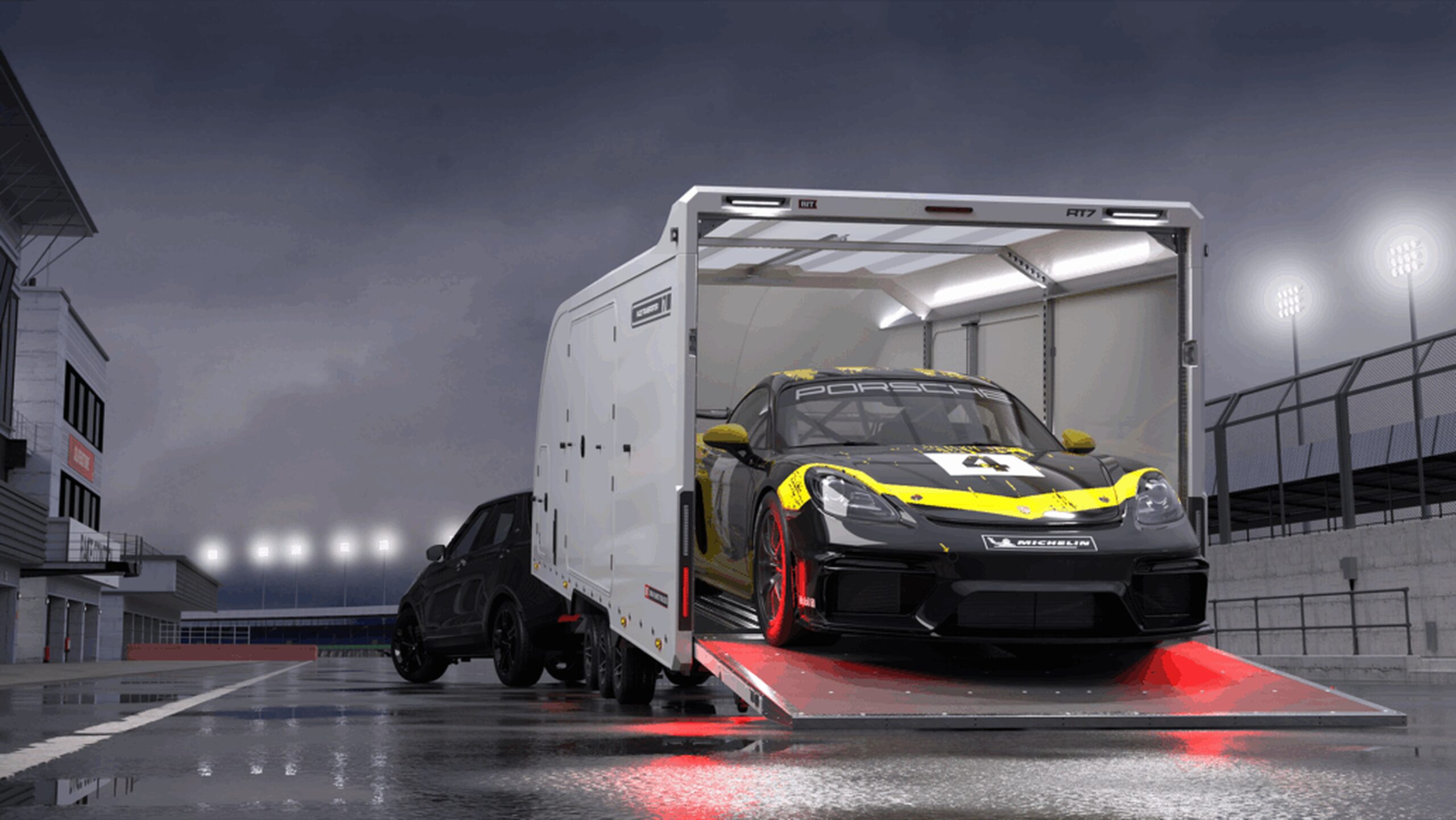 Brian James enclosed car transporter trailer unloading sports car via rear ramp